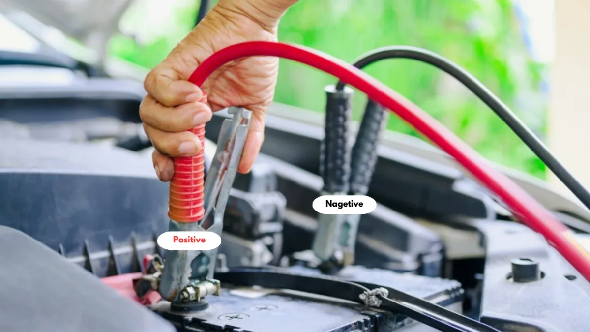 jumper cables connected to car battery
